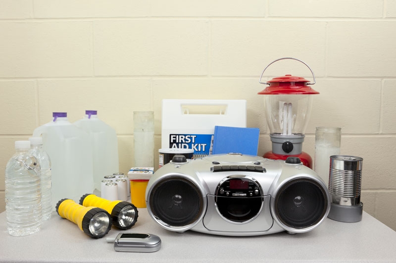 Outage Kit An example of an outage preparation kit with items including a radio, bottled water, battery-operated flashlights